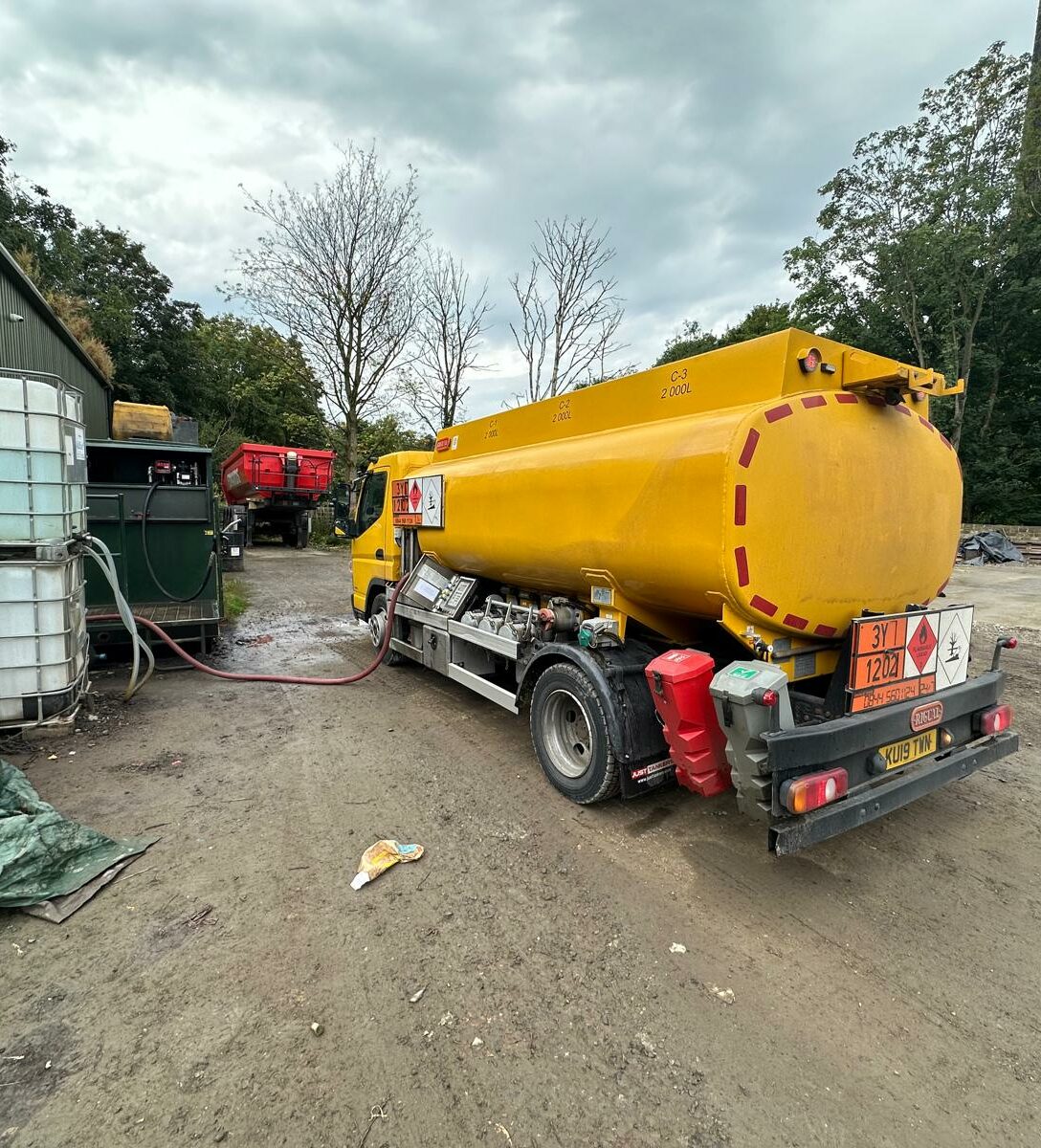 yellow fuel tanker vehicle delivering fuel