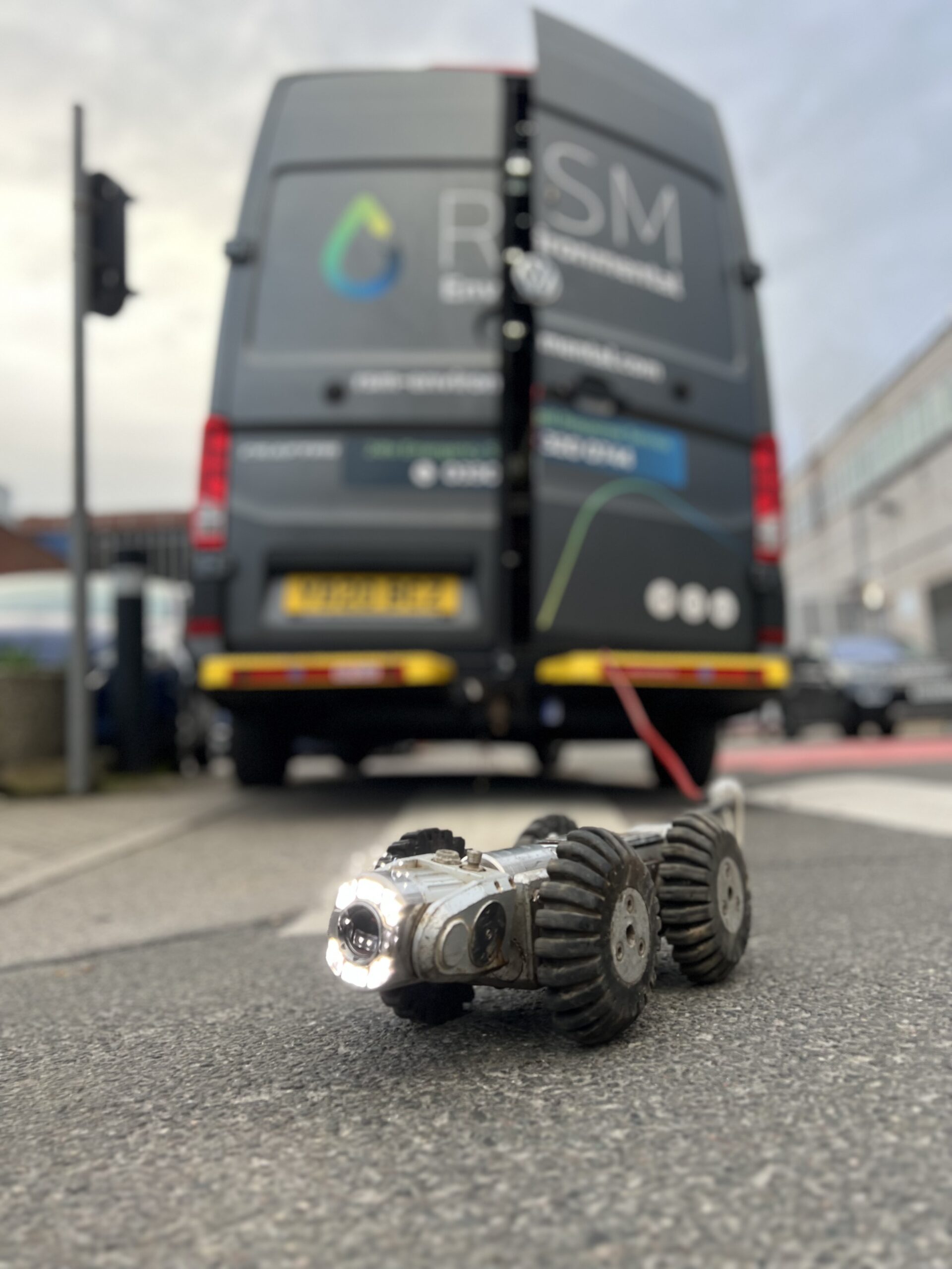 CCTV drainage surveying - robotic camera with 4 wheels in front of RSM truck